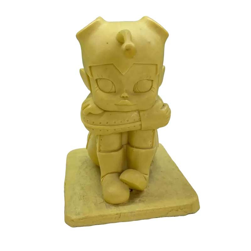 Handheld prototype of a cartoon character printed with yellow wax